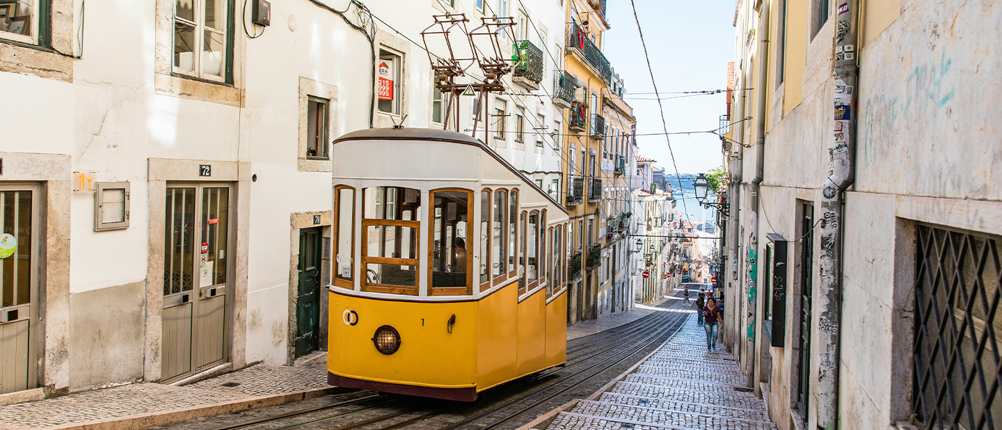 Traditional yellow tram going up a street in Lisbon, the city where the subsidiary of Ferrer laboratories in Portugal operates.