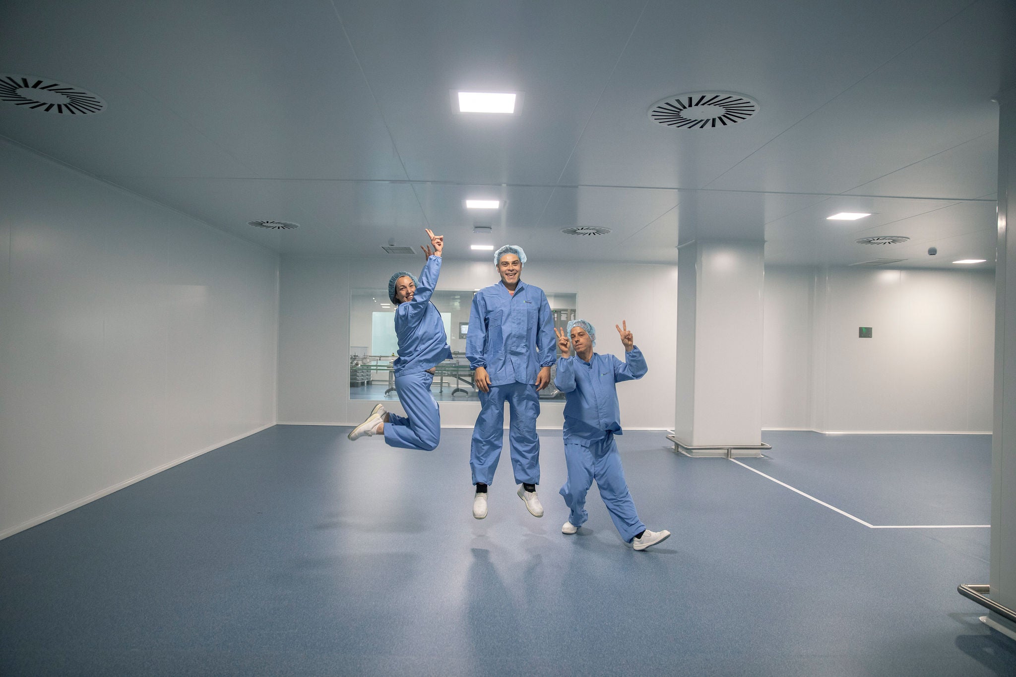 Three employees of Grupo Ferrer jumping to celebrate the company's sixtieth anniversary.