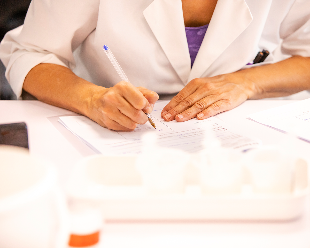 Close-up of a researcher filling out a document in Grupo Ferrer.