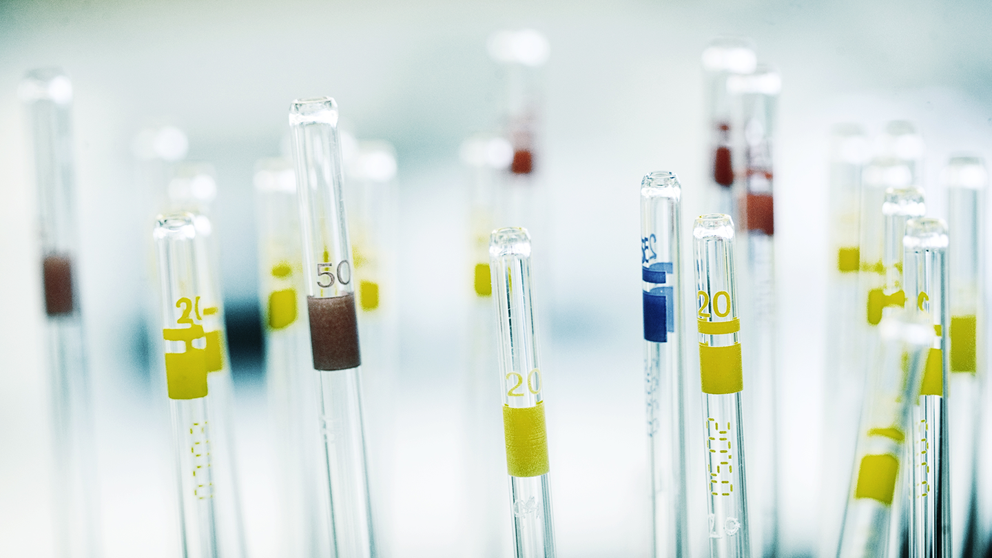 Glass pipettes with measurement marks in a chemical analysis laboratory of the Ferrer company.