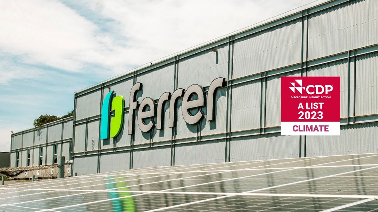 Façade of the Ferrer headquarters with solar panels and the CDP Climate A List 2023 sustainability seal.